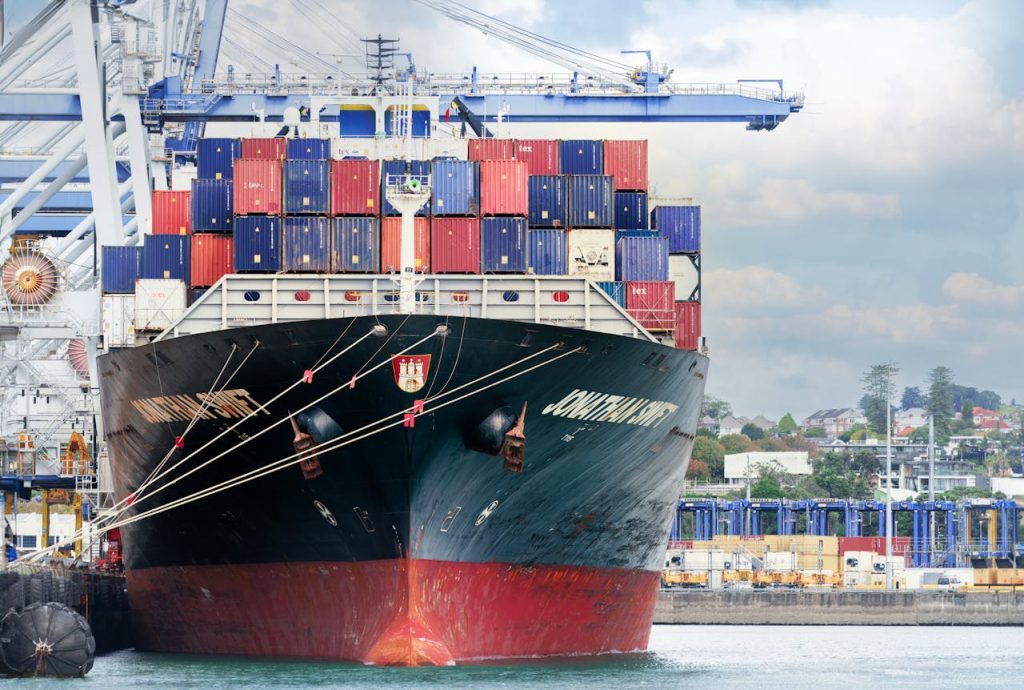 A large container ship is docked at a port